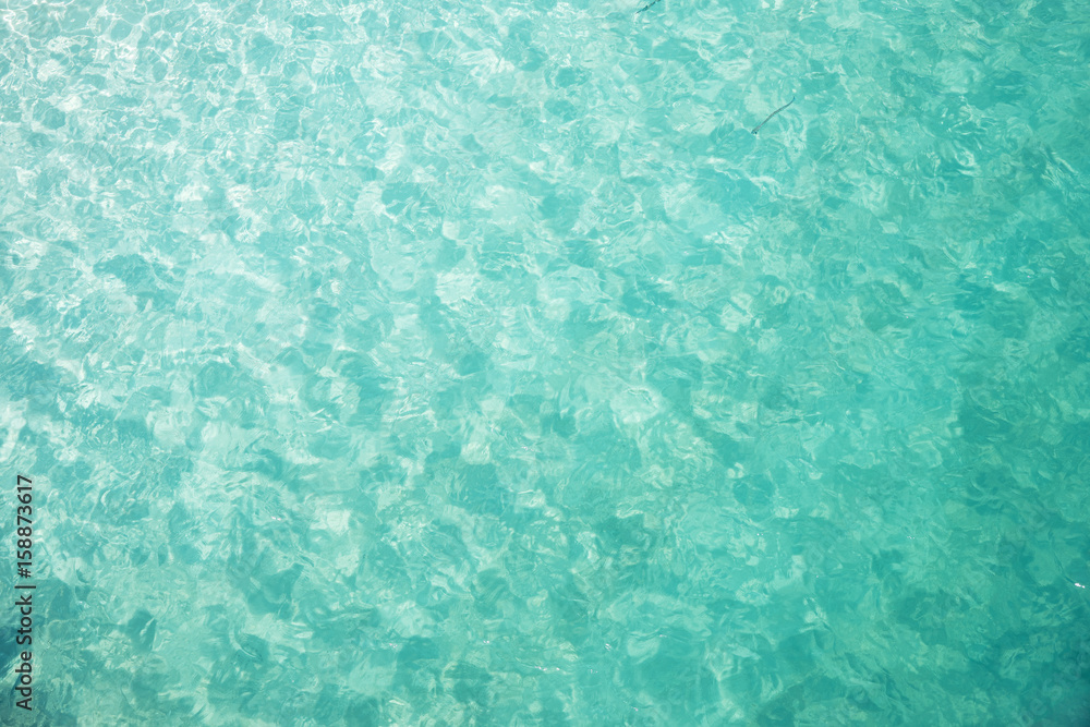 Crystal clear and turquoise sea water of the tropical sea .