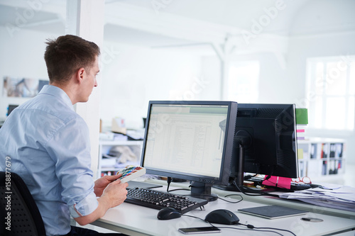 Man in office using computer photo