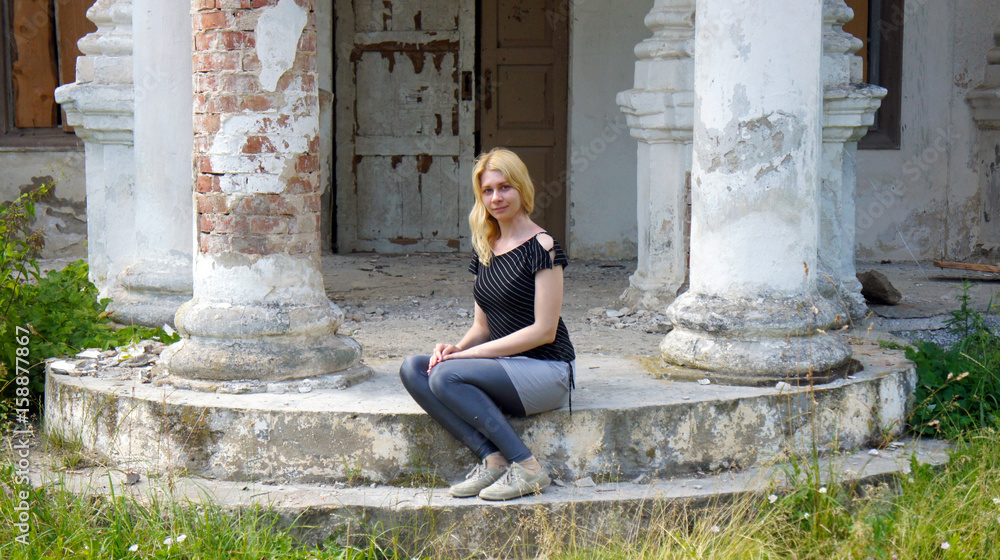 Young woman on the stairs of the old palace Young woman on the stairs of the old palace