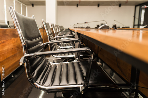 Side view of Conference table and chairs in meeting room photo