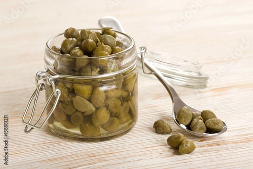 capers on wooden background