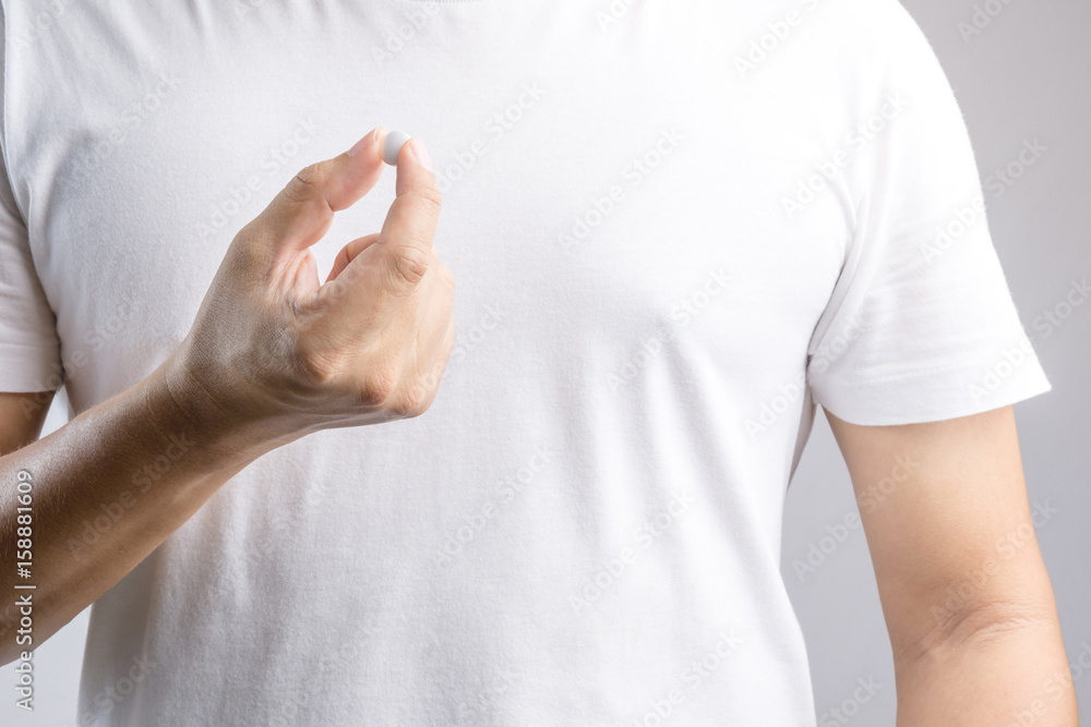Hand holding medical pill Hand holding medical pill