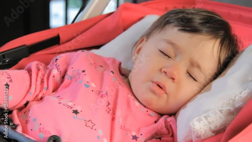 Baby girl stirs in sleep, close up photo