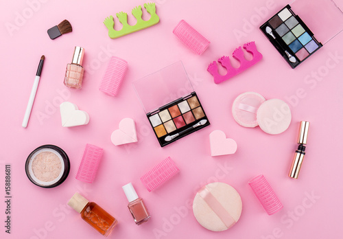 Beauty Spa Feminine Concept. Different Make Up Beauty Care Essentials Cosmetics on Flat Lay Pink Background. Top View. Above.