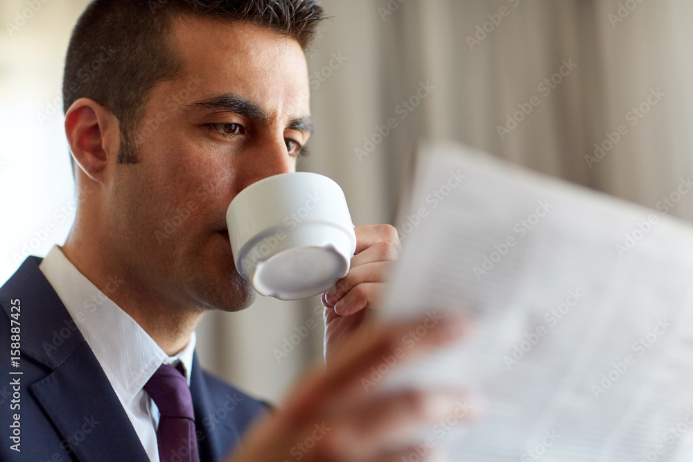 businessman reading newspaper and drinking coffee businessman reading newspaper and drinking coffee