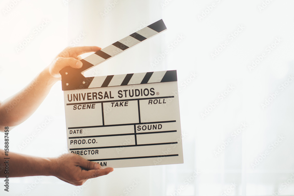Man hands holding film clapper isolated on white background