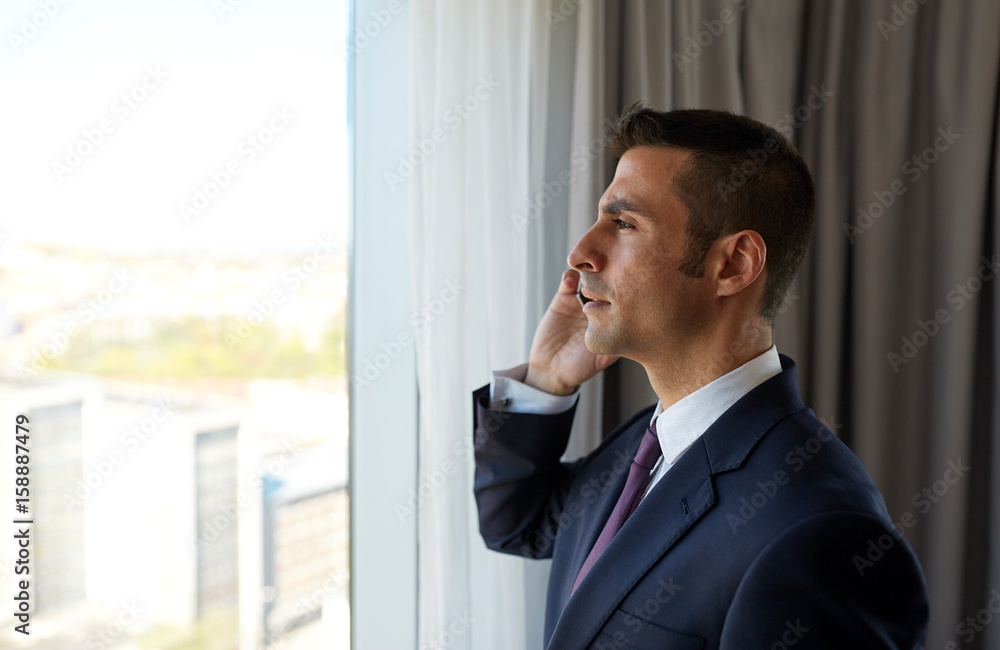businessman calling on smartphone at hotel room businessman calling on smartphone at hotel room