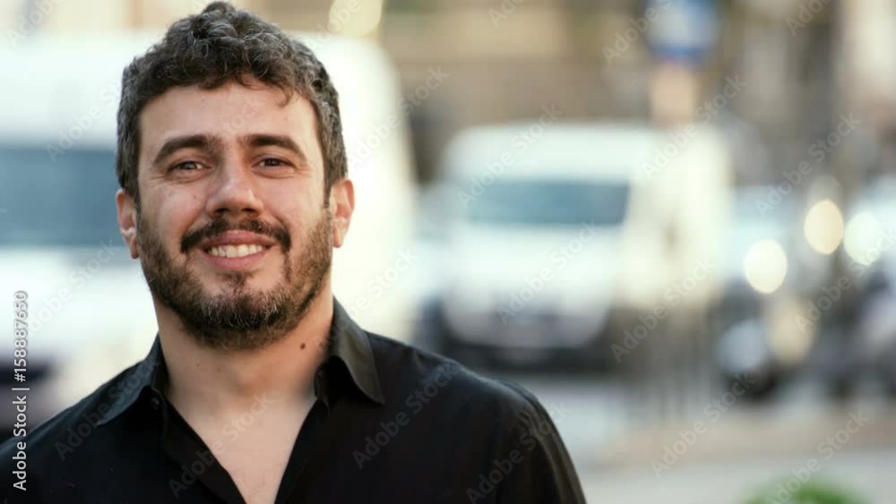 Charming caucasian Man Stands On A street And Smiles At The Camera Charming caucasian Man Stands On A street And Smiles At The Camera