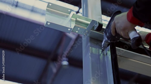 Man using an electric hand drill.