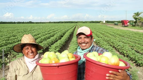 Farmers walk with buckets of fruit, Mexico