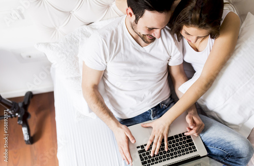 Young couple with laptop in...