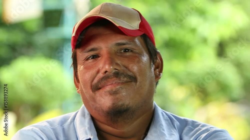 Mexican man puts on hat, close up