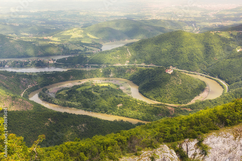 Ovcar Kablar Gorge, Serbia.   Meanders of  West Morava river,  view from the top of the Kablar mountain. Dramatic morning lights and shadows in springtime photo