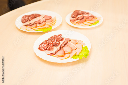 Dish with sliced meat products on the festive table