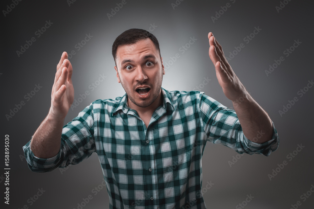 Portrait of man on gray background. Man showing different emotions. Portrait of man on gray background. Man showing different emotions.