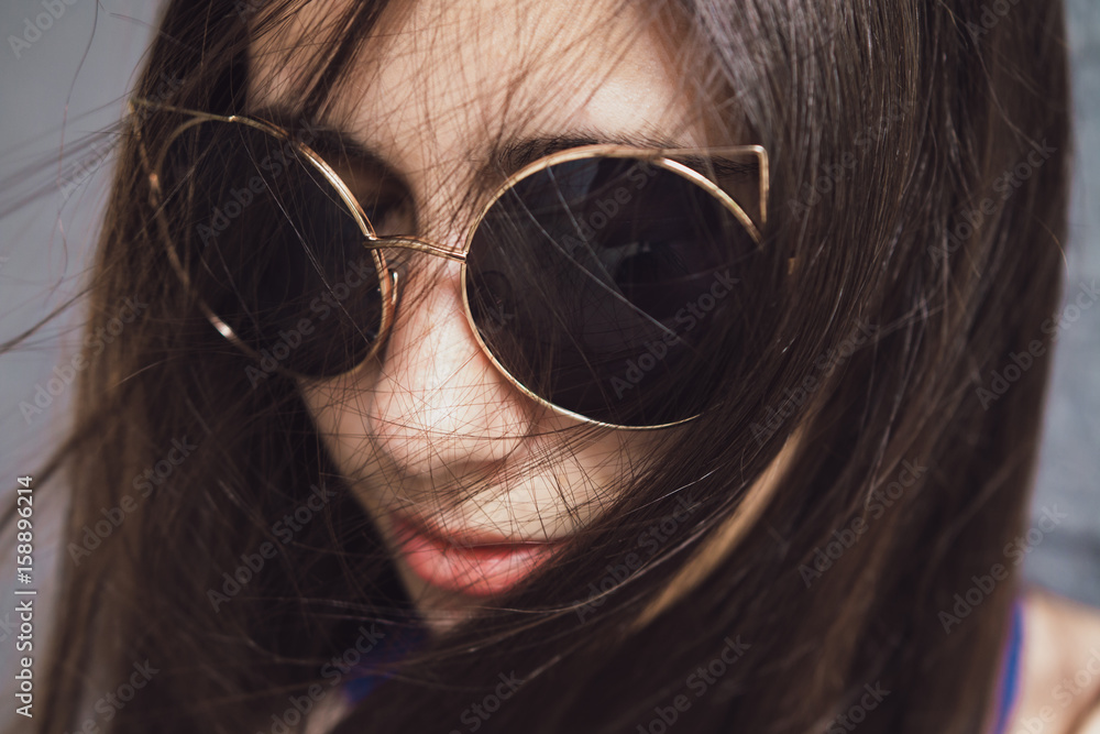 A very beautiful and cheerful girl stands on the street with long, luxurious hair A very beautiful and cheerful girl stands on the street with long, luxurious hair