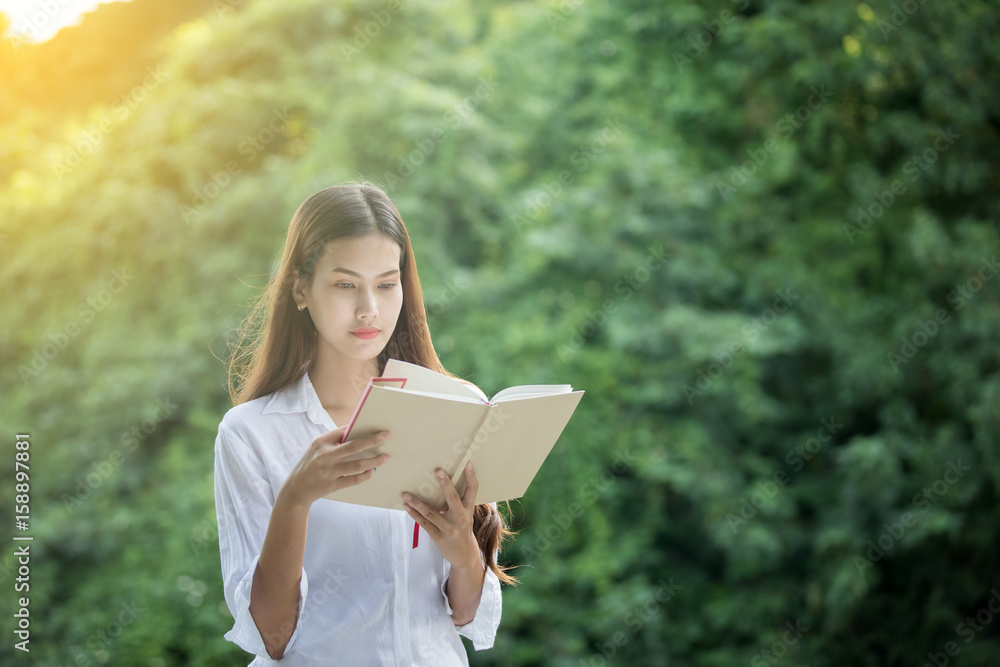 Asian women favourite reading book at outdoor on Amazing time to relax Asian women favourite reading book at outdoor on Amazing time to relax