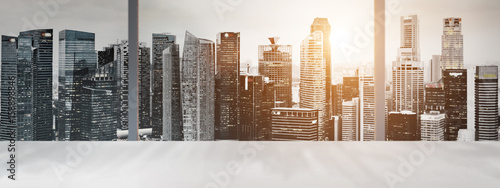 Photography Desk with blurred panoramic view of Singapore downtown and skyline at sunset in office window