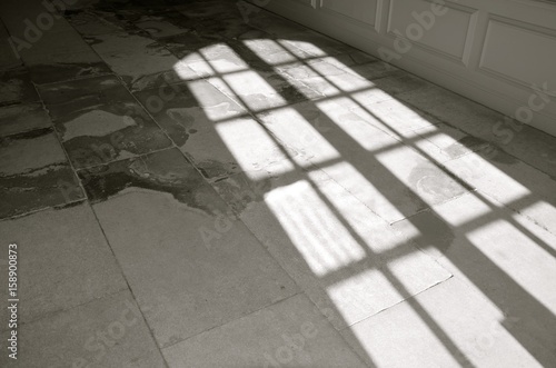 An isolated window shadow on the concept floor. Black and white photo