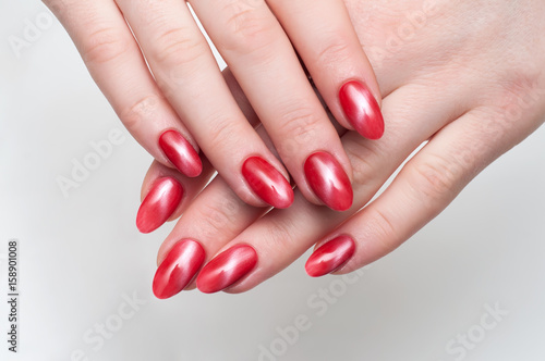 A cat s eye is a red manicure on long  sharp nails.