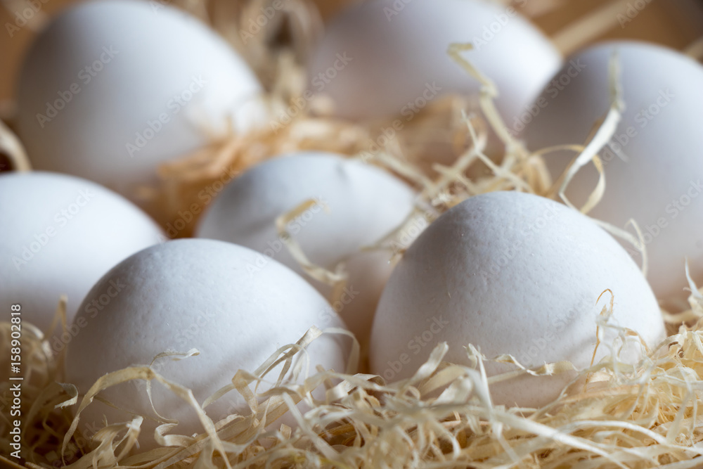 Fresh white uncooked eggs - simple rustic background Fresh white uncooked eggs - simple rustic background