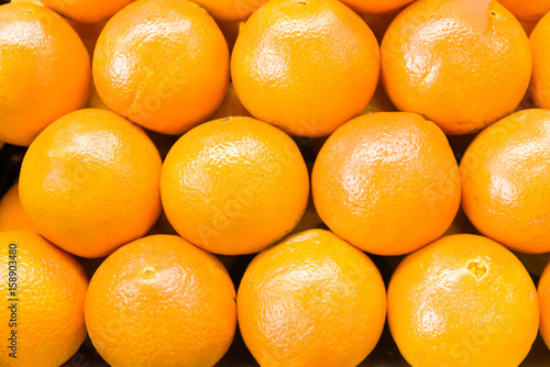 Fresh orange in market. Oranges in row photo