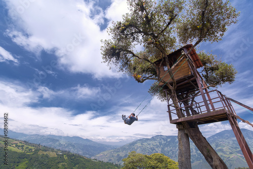 Unknown person swinging at the La casa del Arbol in Banos de Agua Santa, Ecuador
