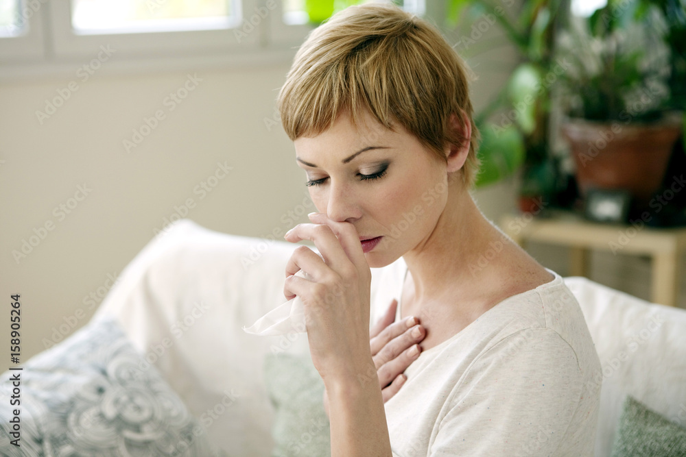 Woman sneezing Woman sneezing