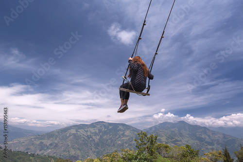 Unknown person swinging at the La casa del Arbol in Banos de Agua Santa, Ecuador