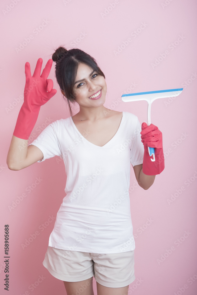 Beautiful asian housewife smiling on pink background Beautiful asian housewife smiling on pink background