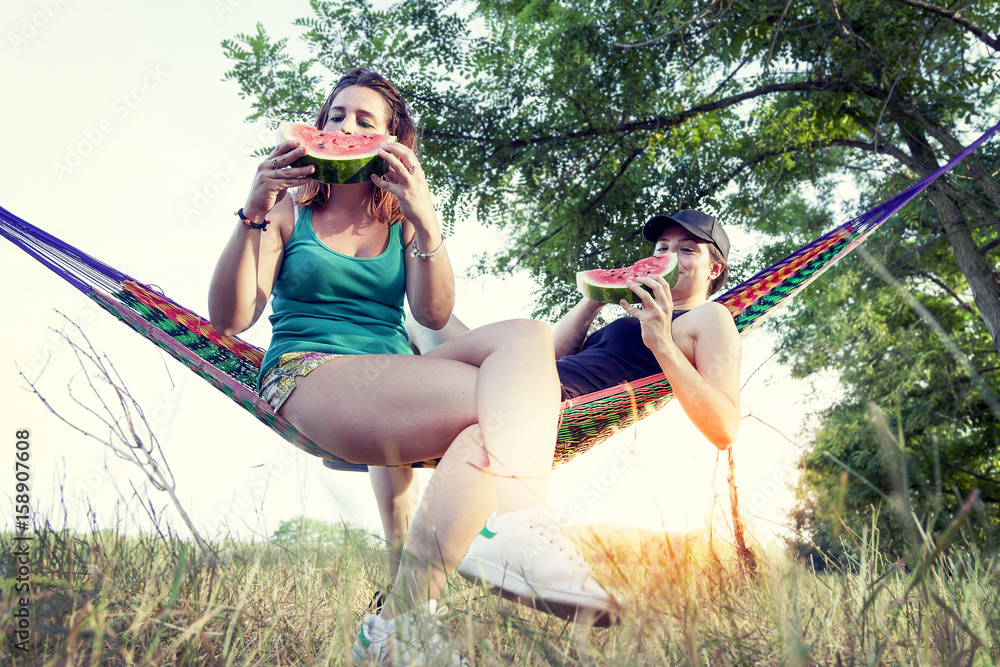 Couple of young beautiful girls eating