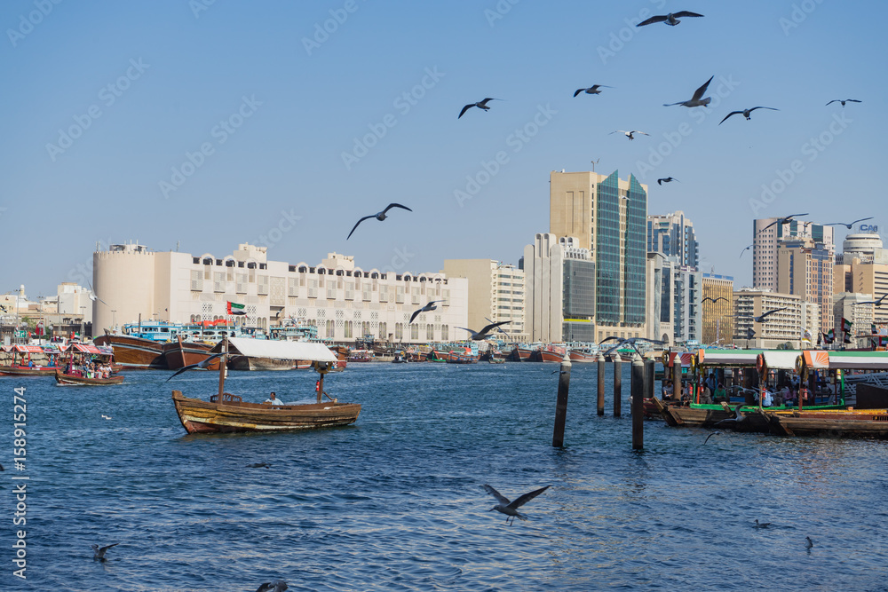 Scenic view of Dubai Creek with seagulls and ferry boats, UAE, United Arab Emirates