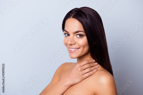 Beauty and health concept. Cose up cropped photo of pretty young latin american woman touching her skin and look so fresh, healthy and attractive