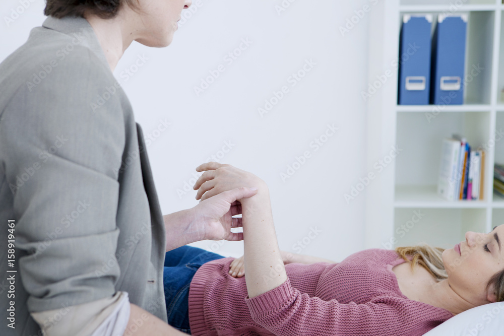 Fototapeta premium Woman undergoing hypnosis session