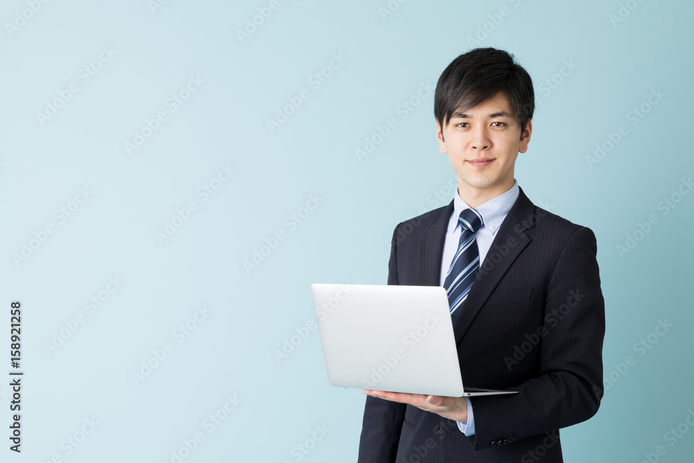portrait of asian businessman isolated on blue background portrait of asian businessman isolated on blue background