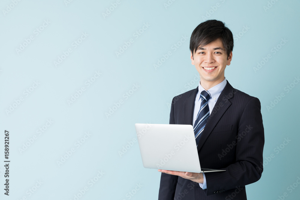 portrait of asian businessman isolated on blue background portrait of asian businessman isolated on blue background