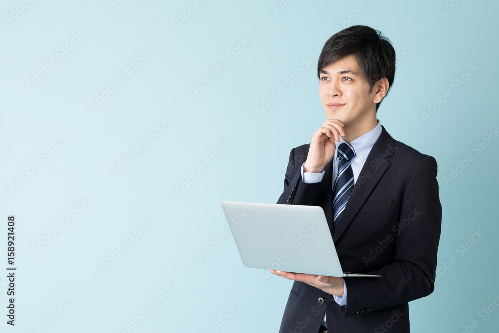 portrait of asian businessman isolated on blue background portrait of asian businessman isolated on blue background
