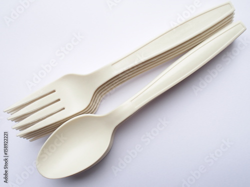 bio plastic spoons and forks on white background