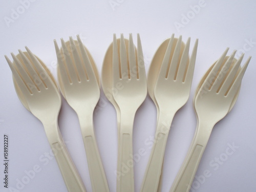 bio plastic spoons and forks on white background