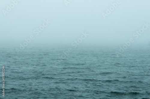 Obraz na plátně Choppy water foggy morning
