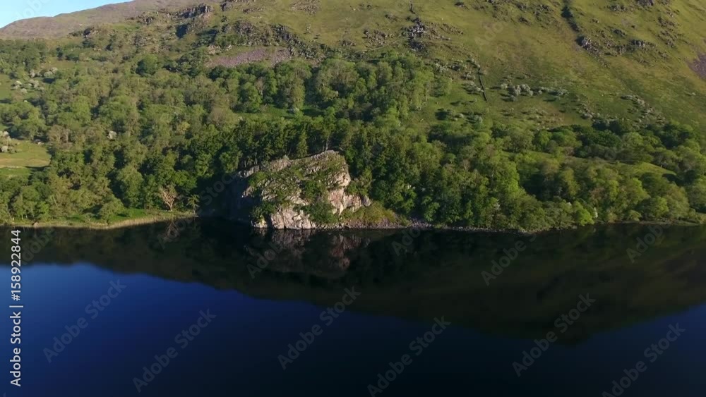 Slow panning reveal over a mountainside lake in Wales, UK. Slow panning reveal over a mountainside lake in Wales, UK.