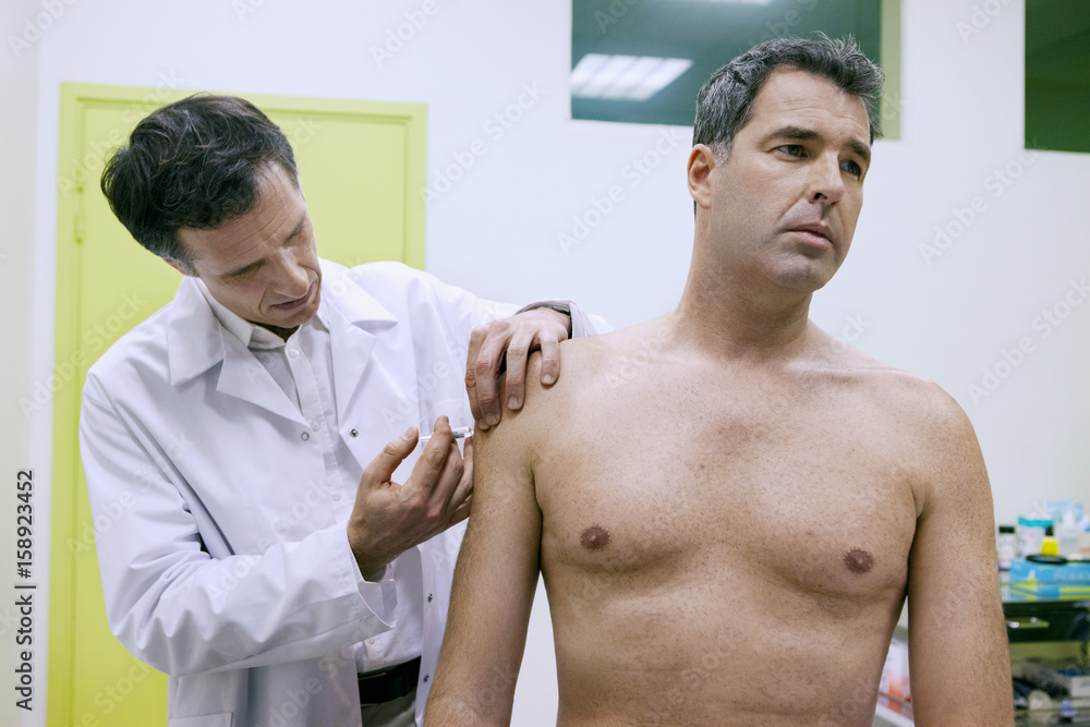 Vaccinating a man Vaccinating a man