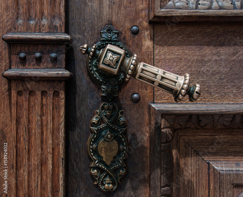 Old wooden door with iron handle on the Franciscans Church of the Annunciation in Ljubljana, Slovenia photo