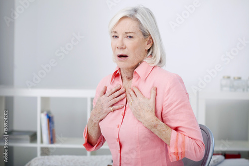 Fotografie Senior woman with breathing difficulties