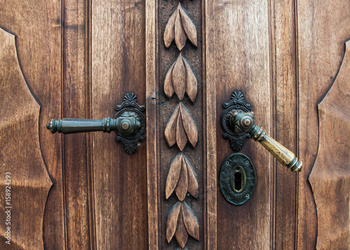 Old wooden door with iron handle on the Prešeren square in Ljubljana, Slovenia photo
