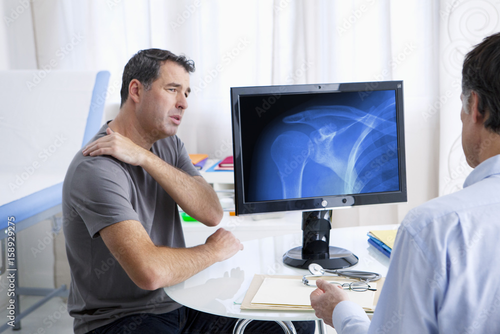 Male patient consulting for shoulder pain Male patient consulting for shoulder pain