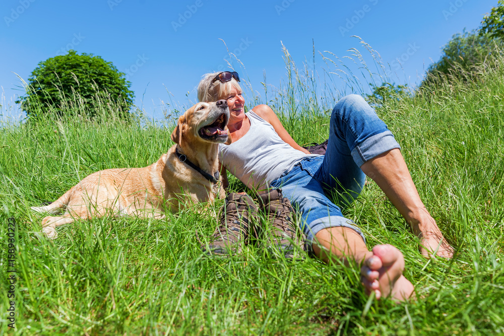 mature woman with dog at a hiking rest mature woman with dog at a hiking rest