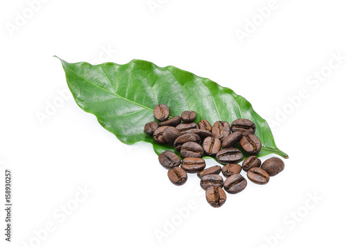 Roasted coffee beans with green coffee leaf isolated on white background