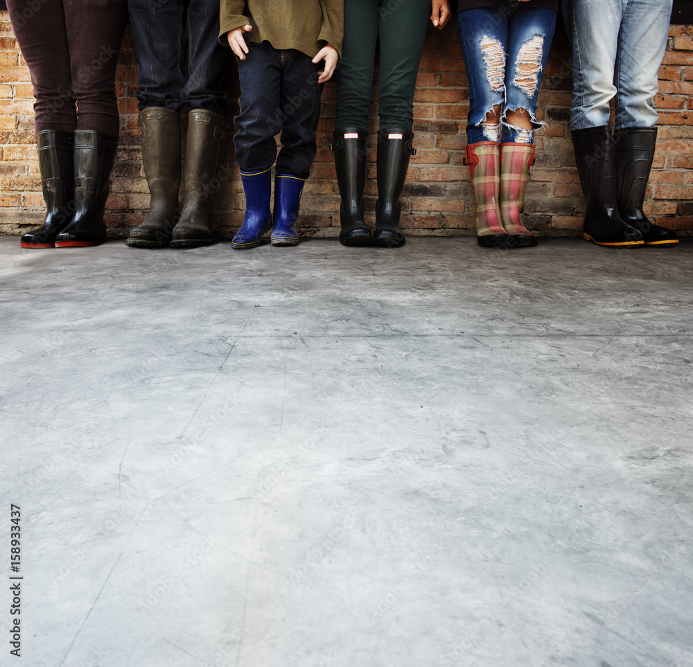 Group of people standing in a row with copy space on concrete floor