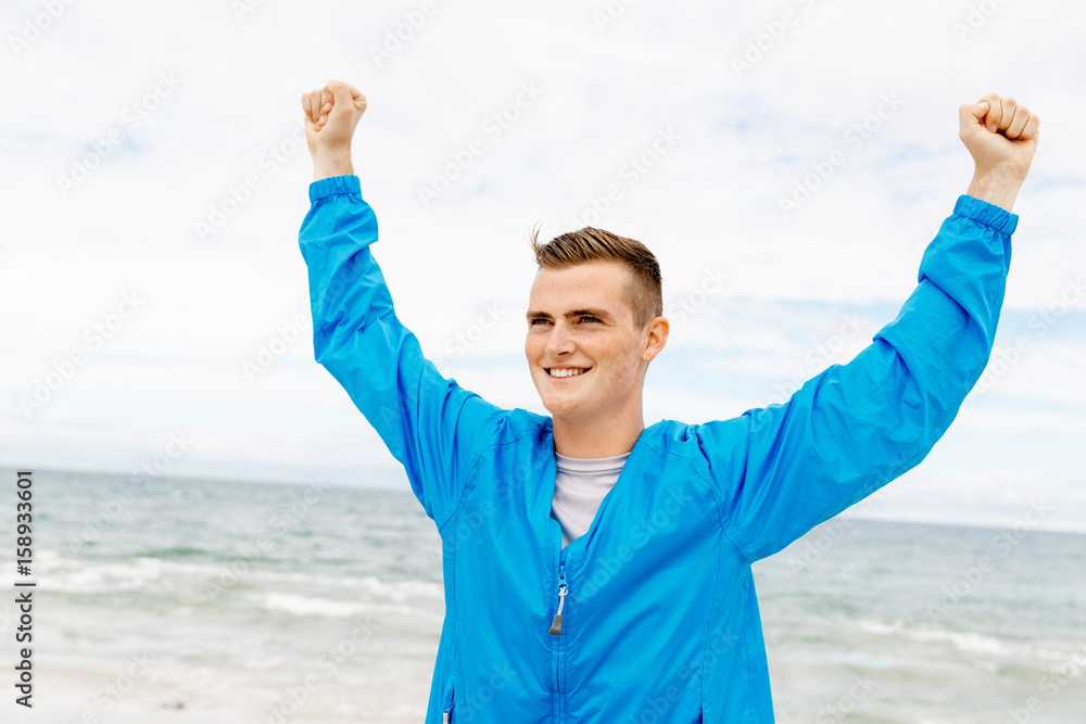 Young man in sport wear with outstretched arms Young man in sport wear with outstretched arms